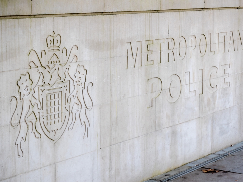 Metropolitan Police sign and logo on a stone wall