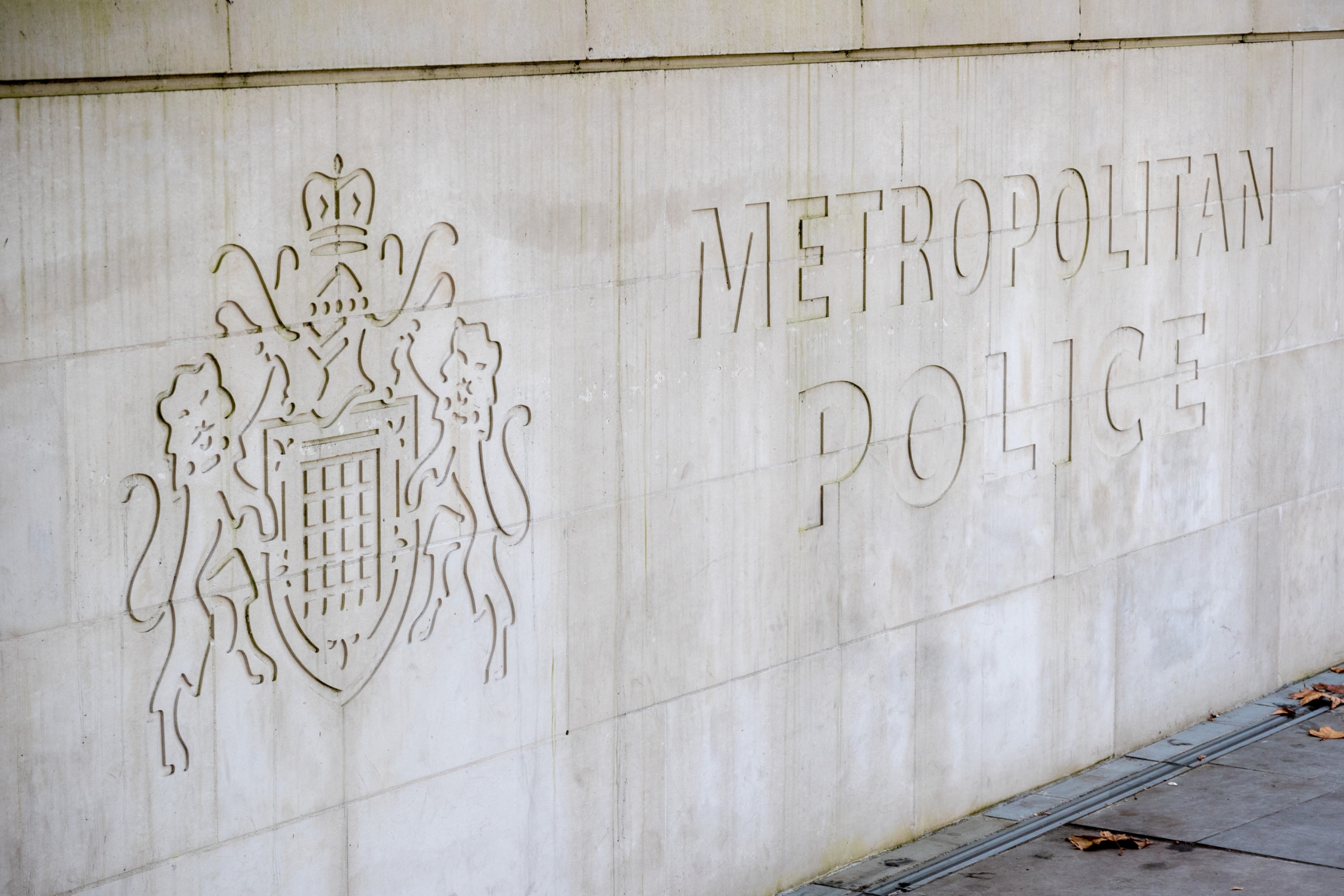 Metropolitan Police sign and logo on a stone wall