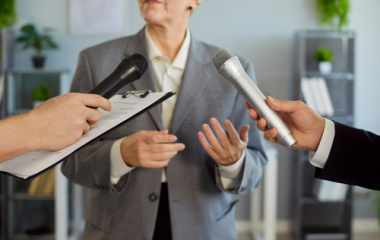 Person standing with two microphones in front of them
